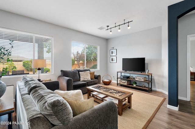 living room with wood-type flooring and track lighting