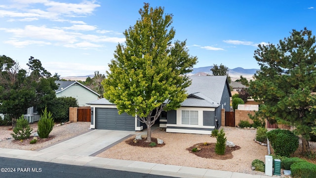 obstructed view of property featuring a mountain view and a garage