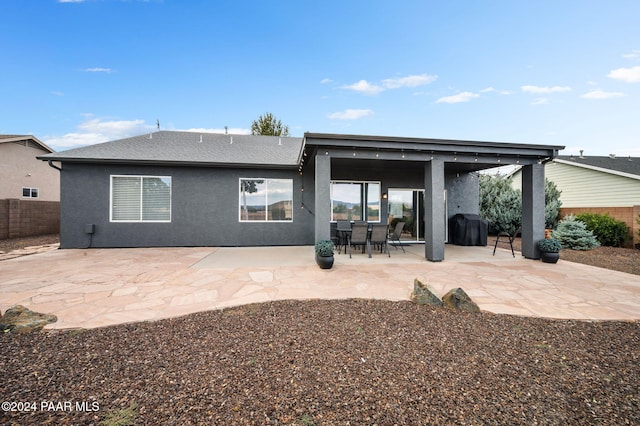 rear view of property featuring a patio