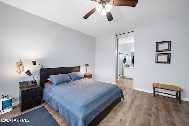 bedroom featuring hardwood / wood-style floors, connected bathroom, and ceiling fan