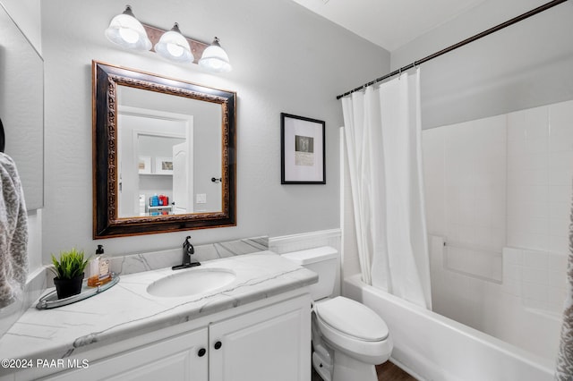 full bathroom featuring shower / bath combo with shower curtain, vanity, and toilet