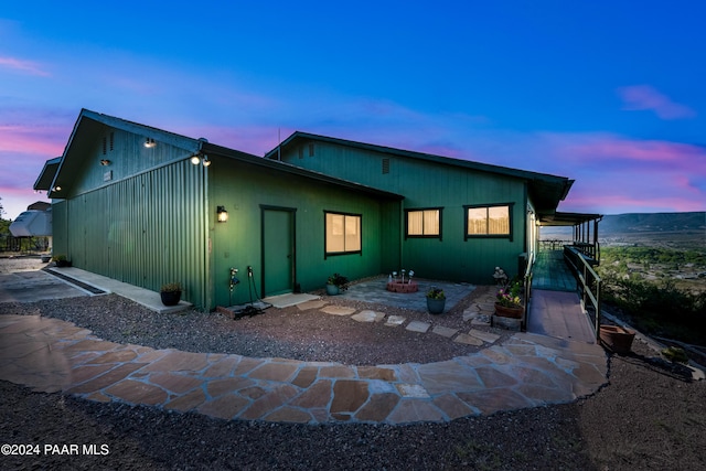 view of back house at dusk