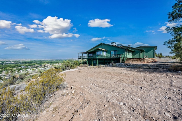 back of property with a wooden deck