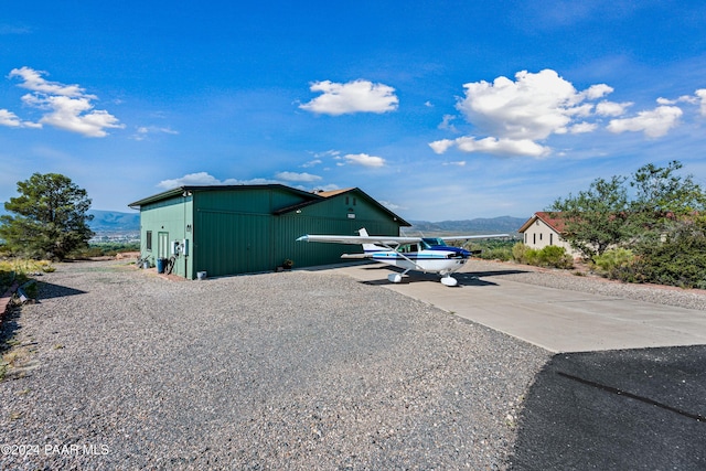 view of property exterior with a mountain view