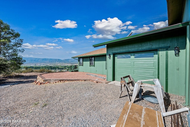 view of side of home featuring a mountain view and a garage