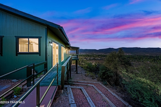 property exterior at dusk with a mountain view