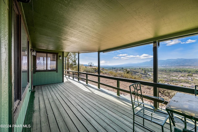 unfurnished sunroom with a mountain view