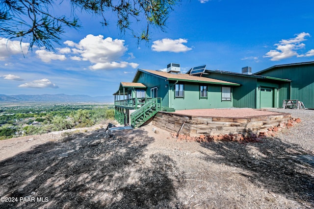 back of property with a mountain view