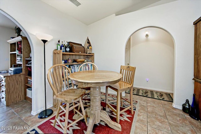6174 N Viewpoint Dr, Prescott Valley, AZ 86314 - tiled dining space with visible vents, arched walkways, and baseboards