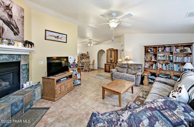 6174 N Viewpoint Dr, Prescott Valley, AZ 86314 - living area with a ceiling fan, a tiled fireplace, arched walkways, light tile patterned flooring, and lofted ceiling