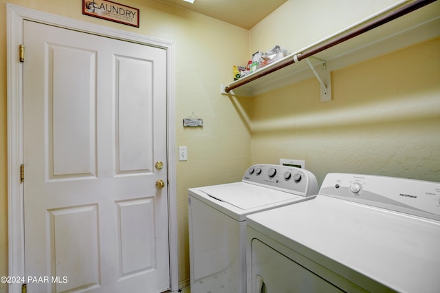 laundry area with washing machine and clothes dryer