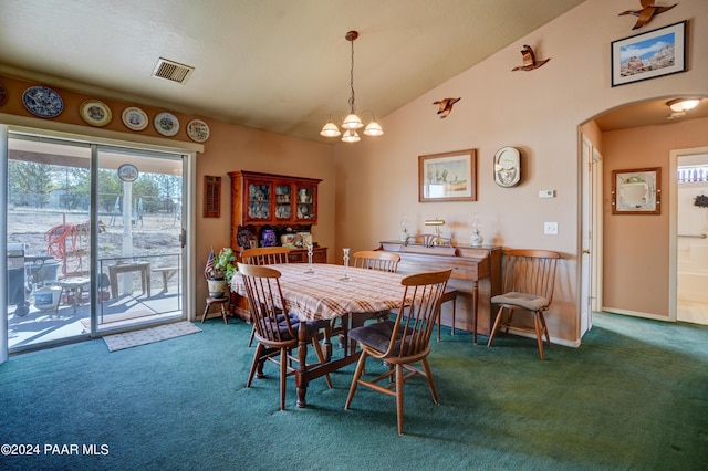 dining space featuring dark carpet, vaulted ceiling, and an inviting chandelier