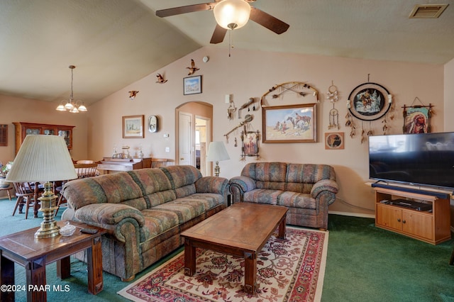 carpeted living room featuring ceiling fan with notable chandelier and vaulted ceiling