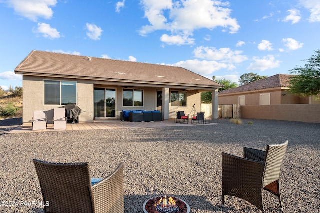 rear view of property featuring a patio area and an outdoor hangout area