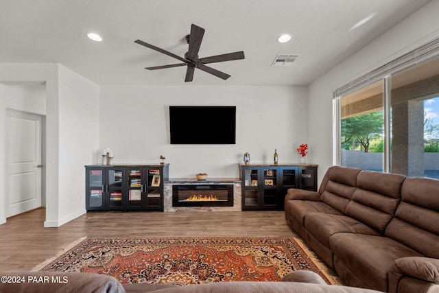 living room with hardwood / wood-style flooring and ceiling fan