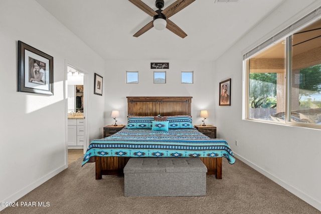 carpeted bedroom featuring connected bathroom and ceiling fan