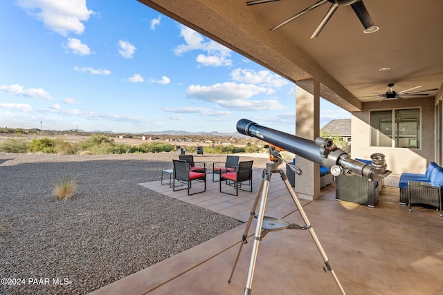 view of patio / terrace with outdoor lounge area, ceiling fan, and a mountain view