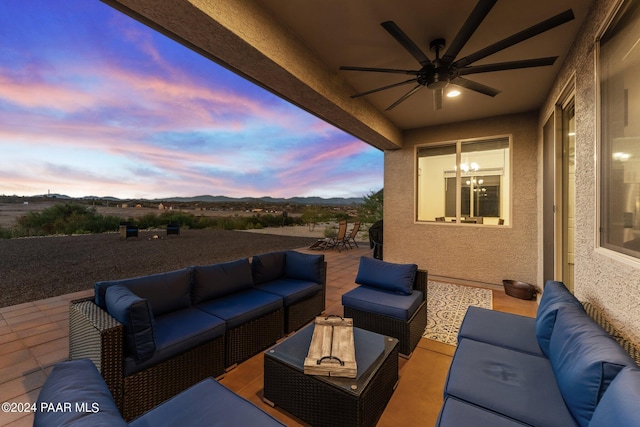 patio terrace at dusk featuring outdoor lounge area and ceiling fan