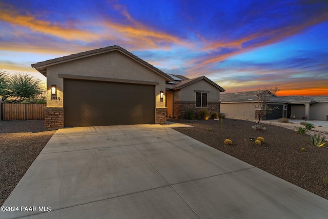 single story home featuring a garage and solar panels