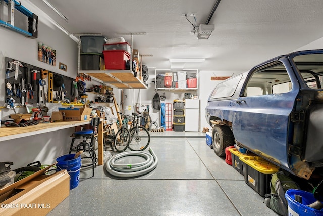 garage with a workshop area and white fridge