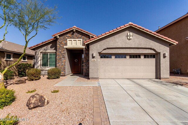 view of front of house with stucco siding, driveway, stone siding, a garage, and a tiled roof