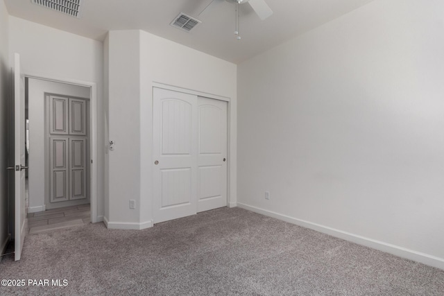 unfurnished bedroom with a closet, baseboards, visible vents, and carpet floors