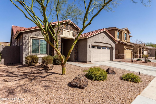 view of front of property with stucco siding, concrete driveway, a garage, stone siding, and a tiled roof