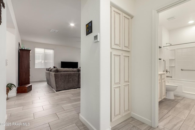 hall featuring recessed lighting, visible vents, wood finish floors, and baseboards