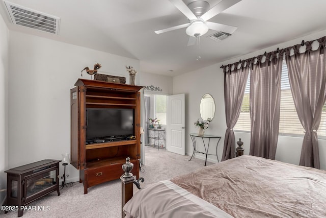 bedroom featuring visible vents, carpet floors, ceiling fan, and vaulted ceiling