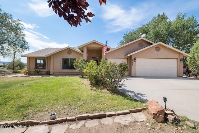 ranch-style home with a garage and a front yard