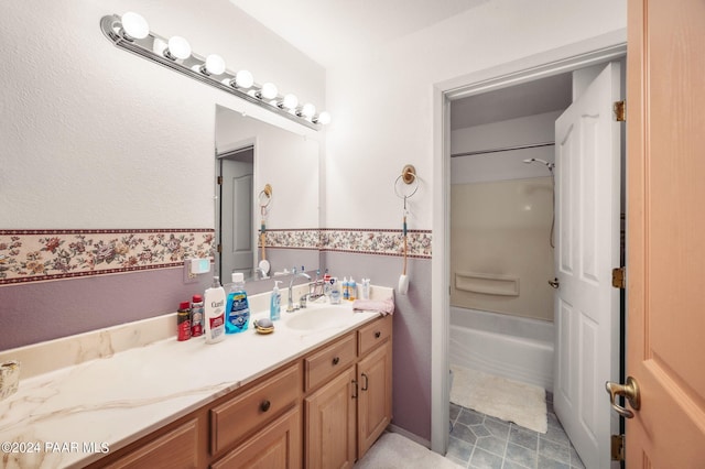 bathroom with washtub / shower combination and vanity