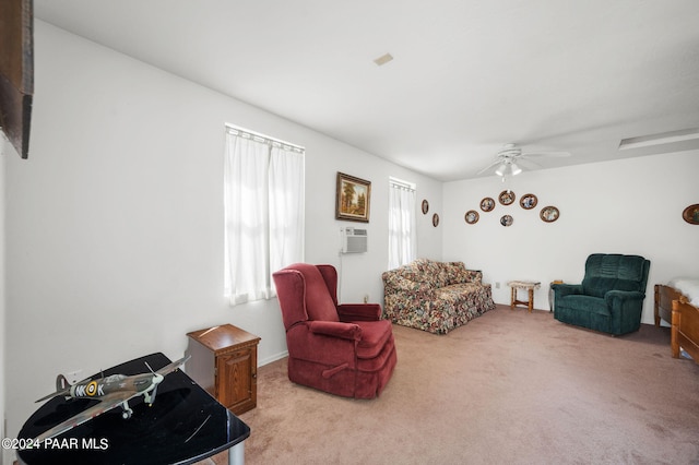 carpeted living room with ceiling fan and a wall unit AC