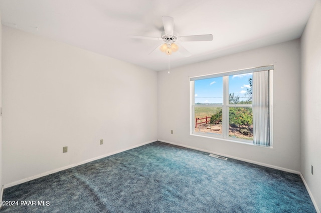 carpeted spare room with ceiling fan