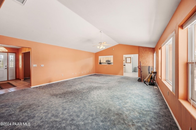 unfurnished living room featuring carpet, ceiling fan, and lofted ceiling