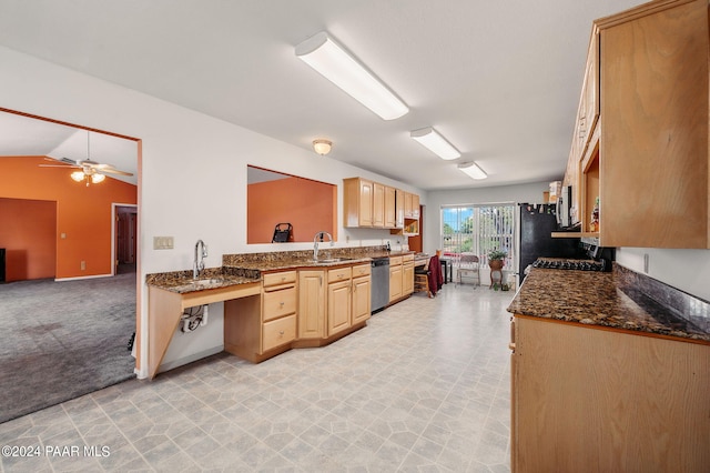 kitchen with light carpet, appliances with stainless steel finishes, light brown cabinetry, vaulted ceiling, and sink