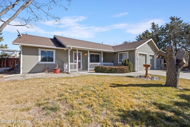 single story home with a garage, a front yard, and covered porch