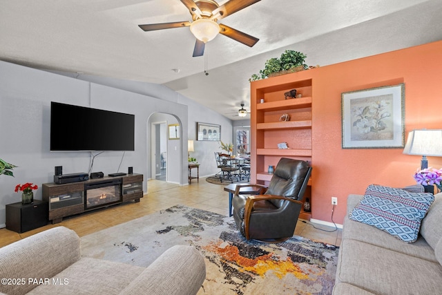 tiled living room featuring lofted ceiling and ceiling fan