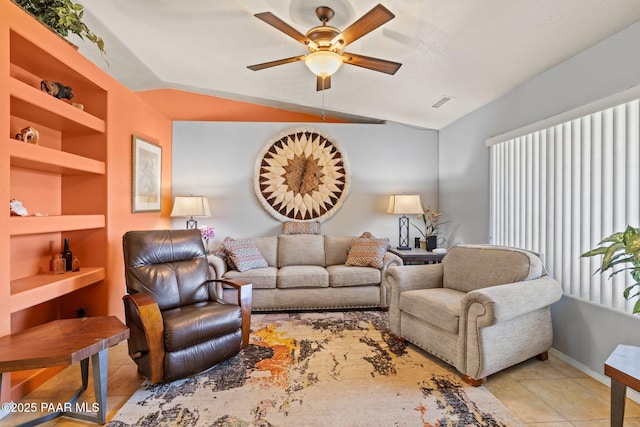 living room featuring built in shelves, ceiling fan, lofted ceiling, and light tile patterned floors