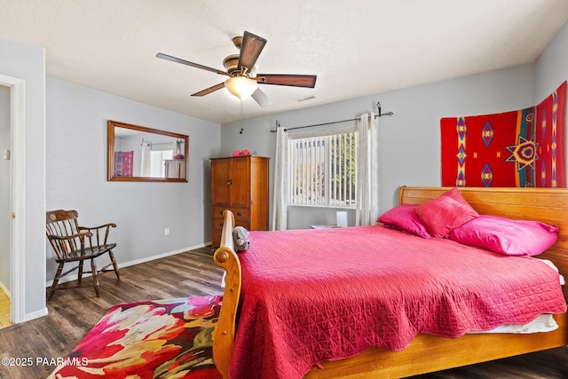 bedroom with dark hardwood / wood-style floors and ceiling fan