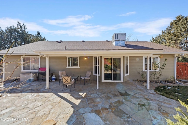 rear view of house featuring cooling unit and a patio