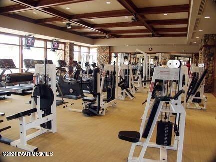 workout area with coffered ceiling