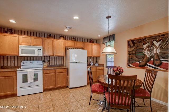 kitchen with recessed lighting, pendant lighting, white appliances, and visible vents