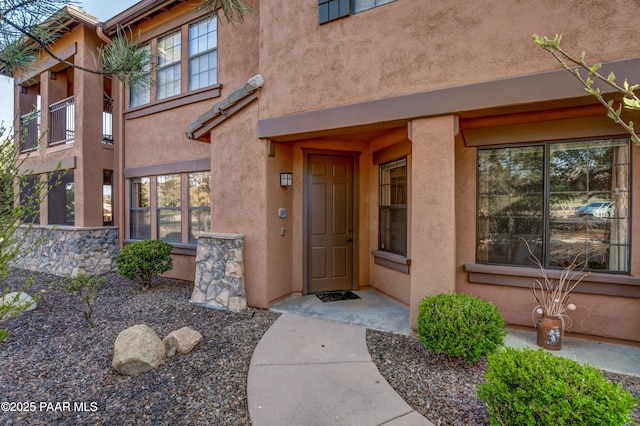 doorway to property with stucco siding