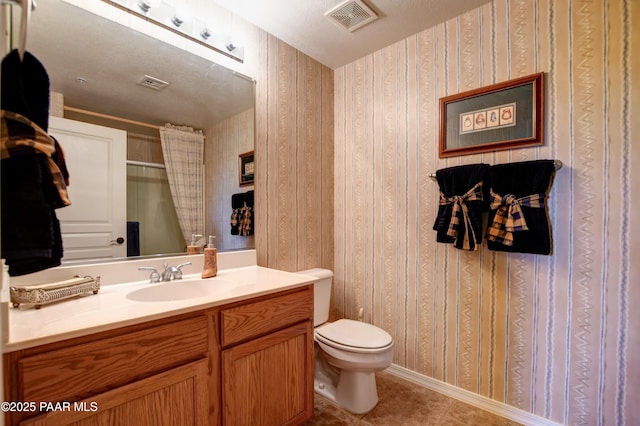 bathroom with tile patterned flooring, vanity, toilet, wallpapered walls, and visible vents