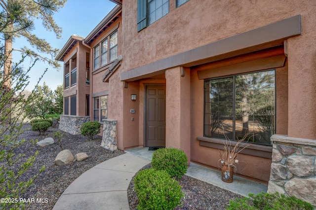 entrance to property with stucco siding