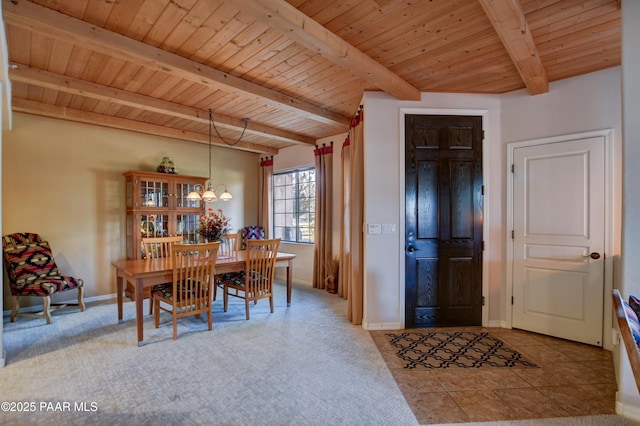 dining room featuring beamed ceiling, an inviting chandelier, wooden ceiling, and baseboards