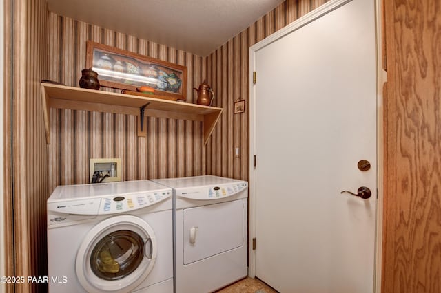 washroom with laundry area, wallpapered walls, and independent washer and dryer