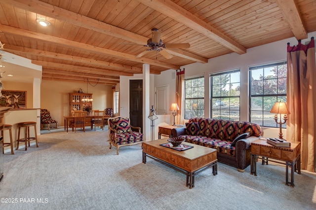 carpeted living area featuring wooden ceiling, beamed ceiling, and a ceiling fan