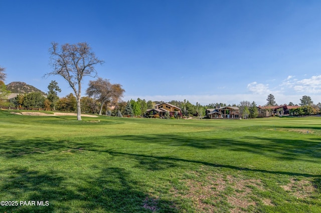 surrounding community with a lawn and golf course view
