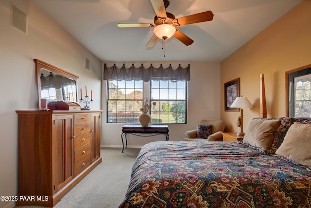 bedroom with light colored carpet, a ceiling fan, baseboards, and visible vents